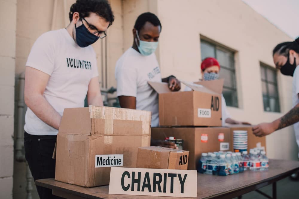 Volunteers packing boxes of food and medicine