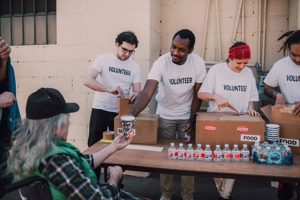 Volunteers handing out drinks and supplies